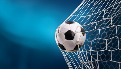 soccer ball in goal net on blue background