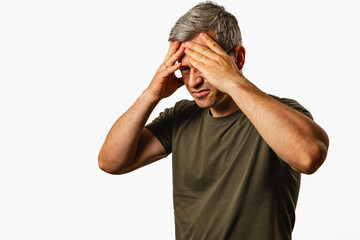Man experiences stress while holding his head in frustration