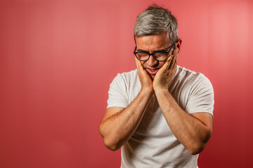 Man expressing concern against a red background