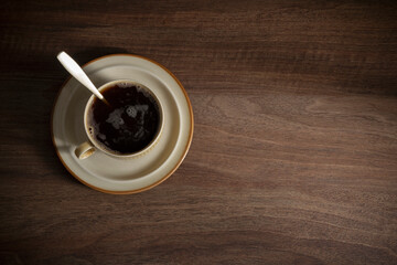  cup of coffee on dark wooden table top view