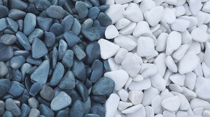 Contrasting composition of blue and white smooth river rocks and pebbles arrangement