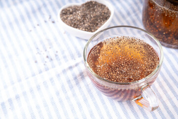 Chia seeds tea, trendy healthy chia infused drink, alternative natural energy source, diet weight-loss drink, in teapot and tea cup, copy space