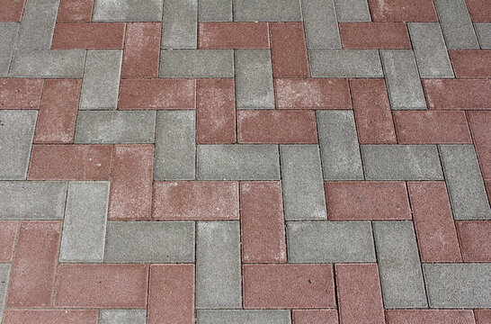 Gray and red paving tile. Brick pavement texture. Interlocking concrete pavers background.