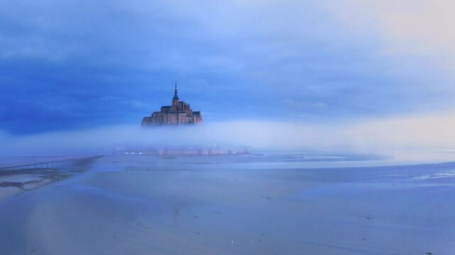 Mont Saint Michel abbey, France, on the blue misty morning