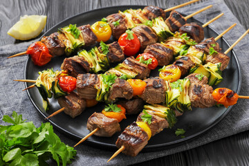 beef kebabs with zucchini and tomatoes on skewers