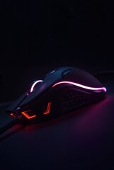Gaming Mouse Illuminated: A close-up shot of a sleek gaming mouse with glowing illumination against a backdrop, offering a glimpse into the world of digital gaming.