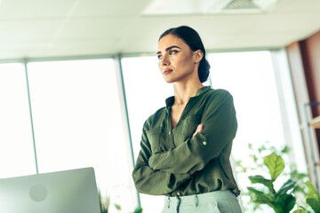 Confident businesswoman in a modern office environment showcasing elegance and professionalism with...