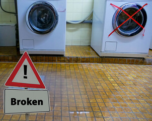 Sign Broken in front of Washing Machine