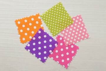 Samples of different fabrics on white wooden table, flat lay