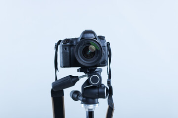 Modern professional video camera on light grey background, closeup