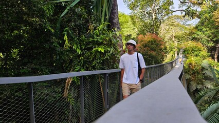 Fototapeta premium Handsome south east asian man travel alone walking calmly in the forest destination