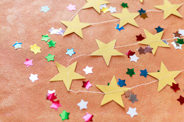 Bright Christmas backgrounds with crumpled paper, fabric, faux fur, bows, confetti, streamers, candy cane baloons, stars, champagne bottle, and festive decor in pink, green, red, peach, purple, gold