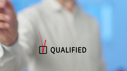 Businessman is checking a red checkbox with the word qualified written next to it, symbolizing...