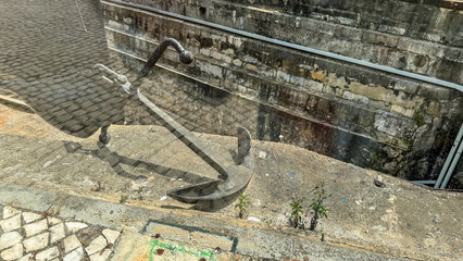 Rusty anchor rests on cobblestones, whispering forgotten maritime tales, capturing Time Travel Days...