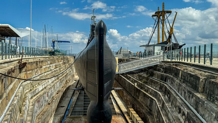 Submarine basking in dry dock, awaiting underwater adventures, evokes Submarine Day mystery and...
