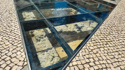 Glass-encased ruins whisper ancient secrets beneath cobblestone reflections, invoking...