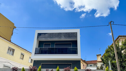 Modern cubic house under azure sky, architectural marvel, minimalist living, evoke Liberation Day,...