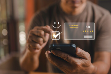 Men use a smartphone to evaluate customer satisfaction with a rating of 5 stars and a smile icon. Satisfaction and the best service rating ideas