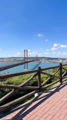 Majestic suspension bridge arches over glistening blue waters, perfect for World Architecture Day...