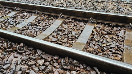 Railway Tracks Close-Up: Detailed view of railway tracks, emphasizing the metal rails, ballast,...