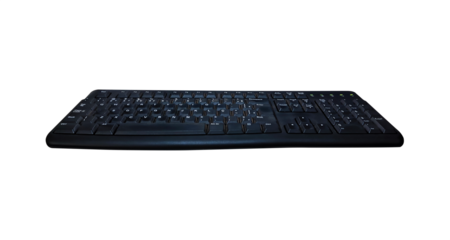 Old black keyboard isolated on transparent PNG background, angled view