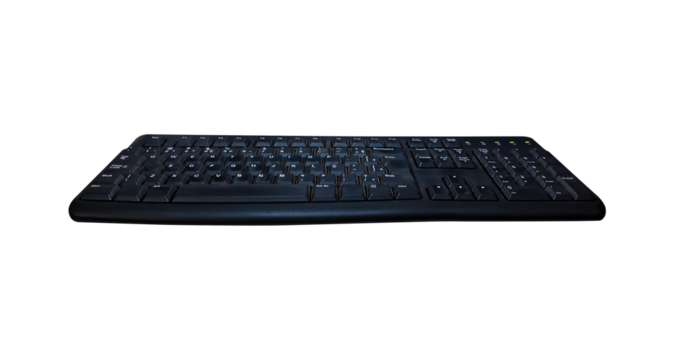 Old black keyboard isolated on transparent PNG background, angled view