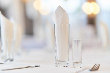 Glass with a glass on the festive table. Festive table setting.