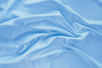 Light blue silk fabric with glossy waves and gentle wrinkles. High-quality draped. Ideal for...