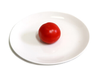 One red tomato on a white plate