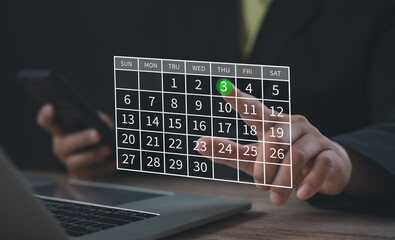 Individual selecting a date on a virtual calendar interface over a laptop, symbolizing efficient scheduling, task planning, digital productivity, and modern time management in business operations.
