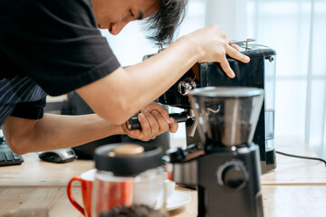 A young Asian male barista, dressed in a striped apron, skillfully creates beautiful latte art in a cozy, modern cafe, professional coffee equipment and takeaway cups.
