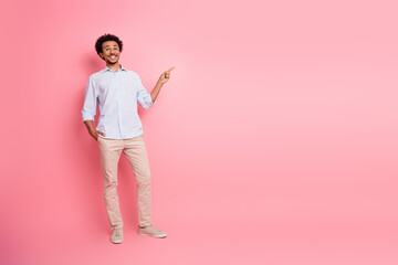 Young professional man gesturing confidently with hand against pink background promoting style and...