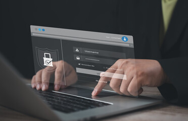 Professional accessing secure login page on laptop screen with shield icon and password input,...