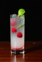 Raspberry Cocktail: A refreshing and visually appealing cocktail is presented in a tall glass. It showcases plump raspberries, fresh basil, and effervescent bubbles.