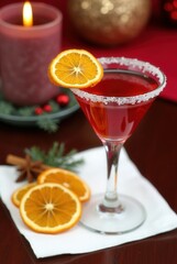 Cranberry Festive Cocktail: A vibrant cranberry cocktail garnished with sugared rim, orange slices, and star anise, perfect for Christmas or winter celebrations.