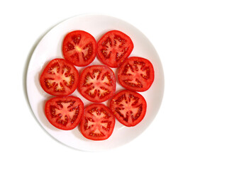 Fresh red tomato slices on a plate isolated on white background