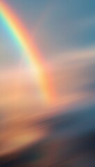 Vibrant rainbow stretches across a dreamy sky with soft pastel colors in the atmosphere