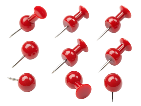 A group of seven red push pins arranged on a black background in a studio setting with soft lighting