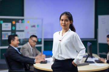 Portrait Asian business woman : Young confident smiling Asian business woman leader, professional entrepreneur company executive ceo manager. Team meeting