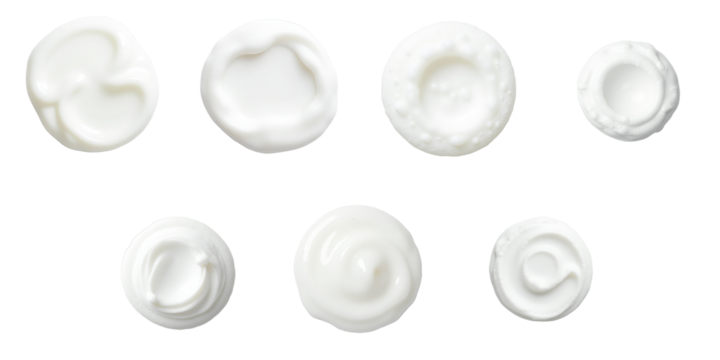 Top view of various cream or foam textures on a transparent background displaying different shapes and patterns, representing shaving cream, bath foam, or cosmetic products, isolated for clarity.