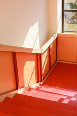 Creative and minimalist interiors featuring bright colors, red staircase, cozy corners, plants, and decorative elements. A celebration of color and comfort in interior design and home decor