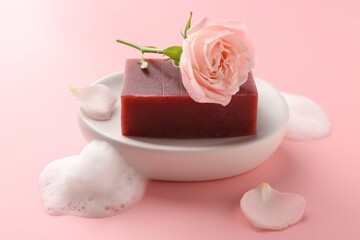 Soap bar and beautiful rose on pink background, closeup