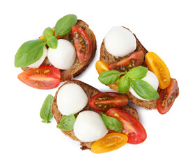 Tasty sandwiches with mozzarella cheese, tomatoes and basil isolated on white, top view