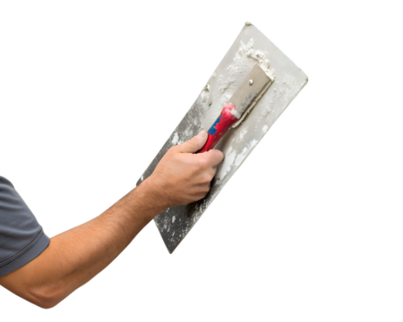 A hand holding a metal trowel with a red handle. The trowel is covered in plaster, set against a transparent background.