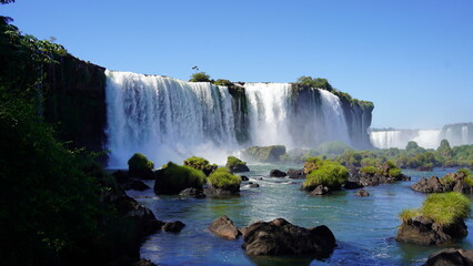 Stunning view of Iguazu Falls cascading through lush rainforest on the border of Brazil and Argentina, showcasing powerful waterfalls, mist, and vibrant natural beauty © Mark