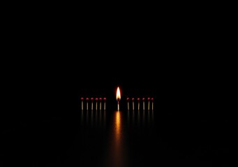 A single lit matchstick glows brightly among unlit black matchsticks, highlighting the contrast between light and darkness.