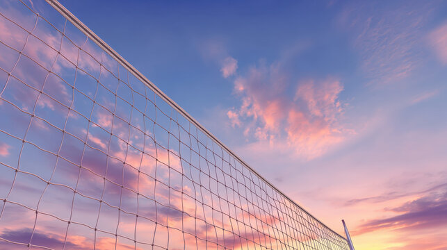 A volleyball net stands against a colorful sunset sky, ready for fun sports activities on the beach during the evening - Powered by Adobe