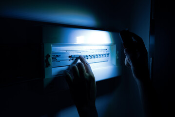 Investigate a home fuse box during a power outage