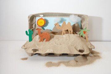 Creative desert model in egg carton with animals and scenery, perfect for art teachers, educational publishers, eco toy makers, kids books, sustainability brands, homeschool programs,
