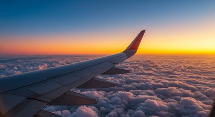 Obraz premium Airplane wing soaring above clouds during stunning sunset emitting golden light